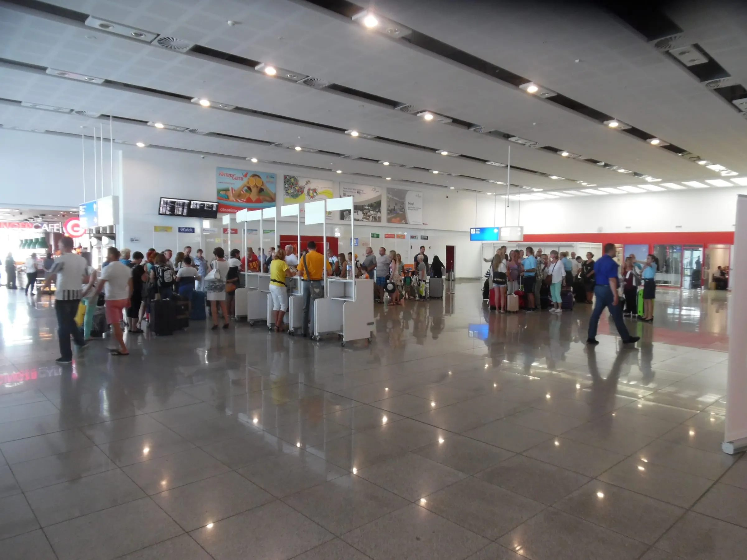 The arrivals hall at Burgas Airport with passengers queueing with their luggage