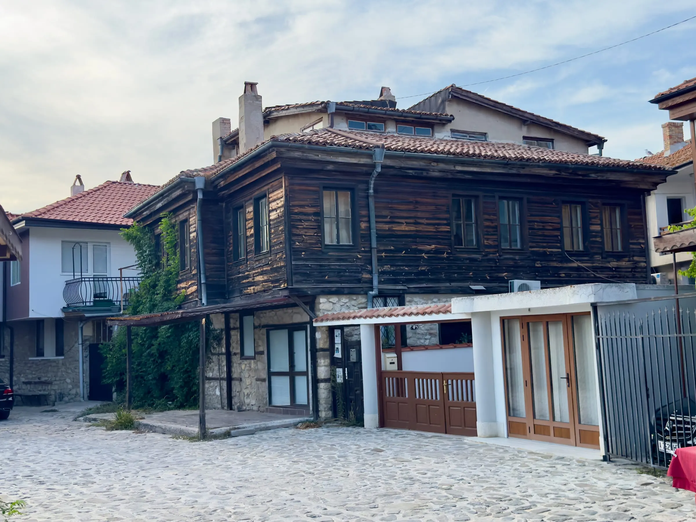 A cobbled lane in Nessebar Old Town lined with timber houses on stone ground floors