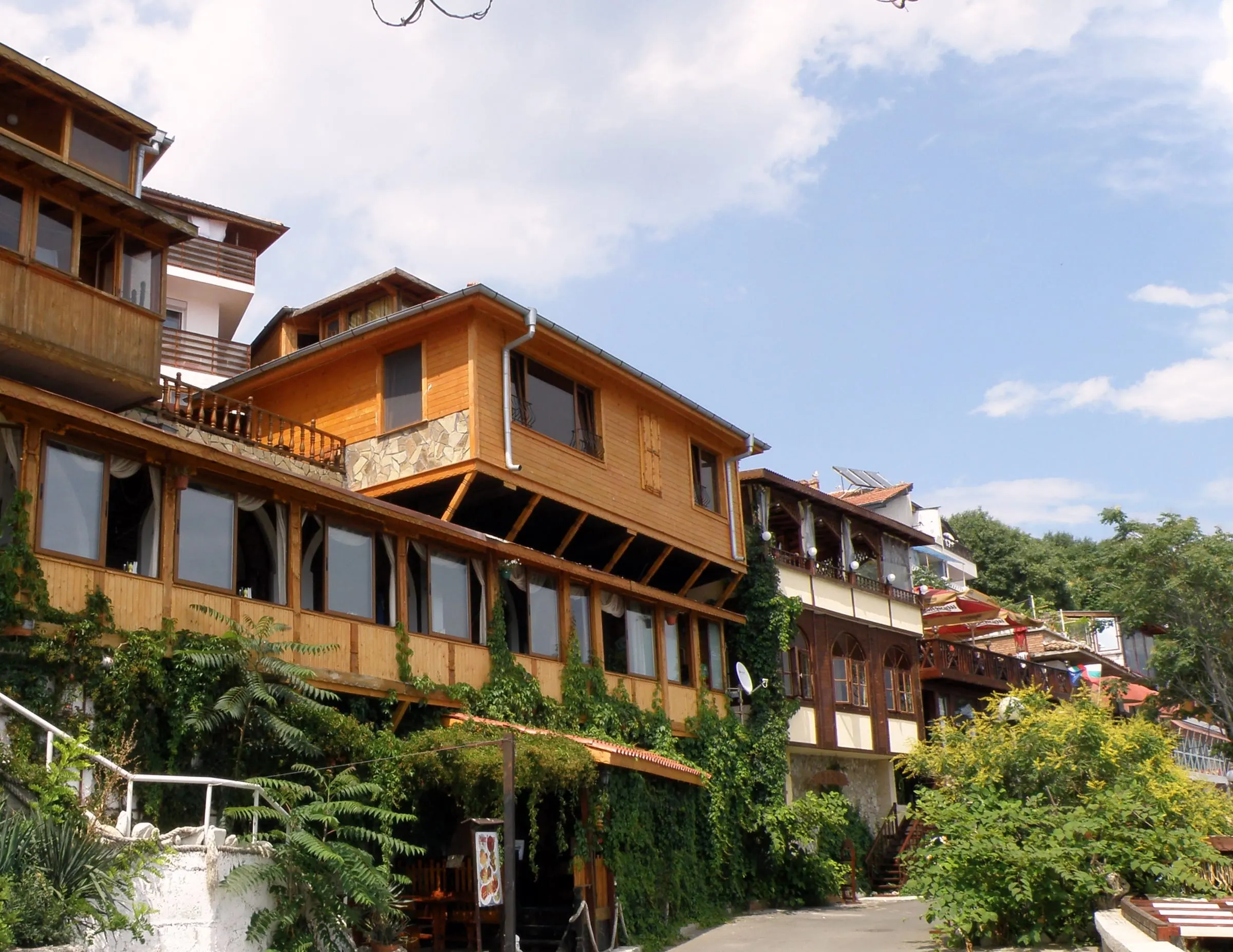 Timber National Revival houses above stone ground floors in Nessebar's old town
